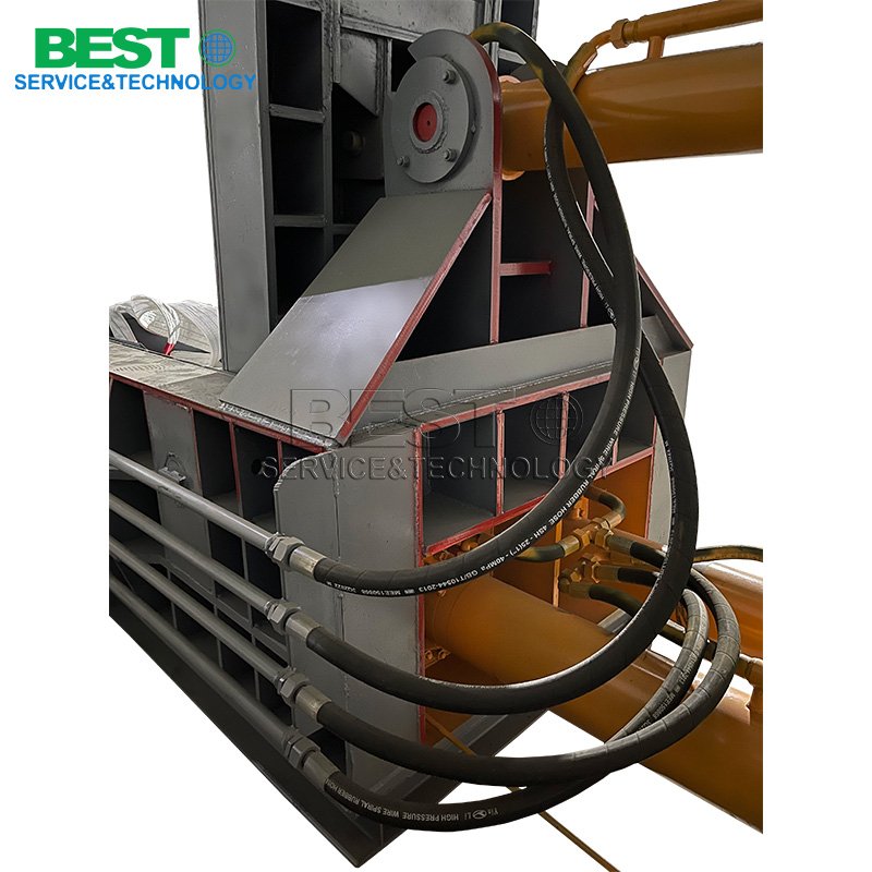 Waste metal briquetting machine running in scrap metal recycling factory workshop