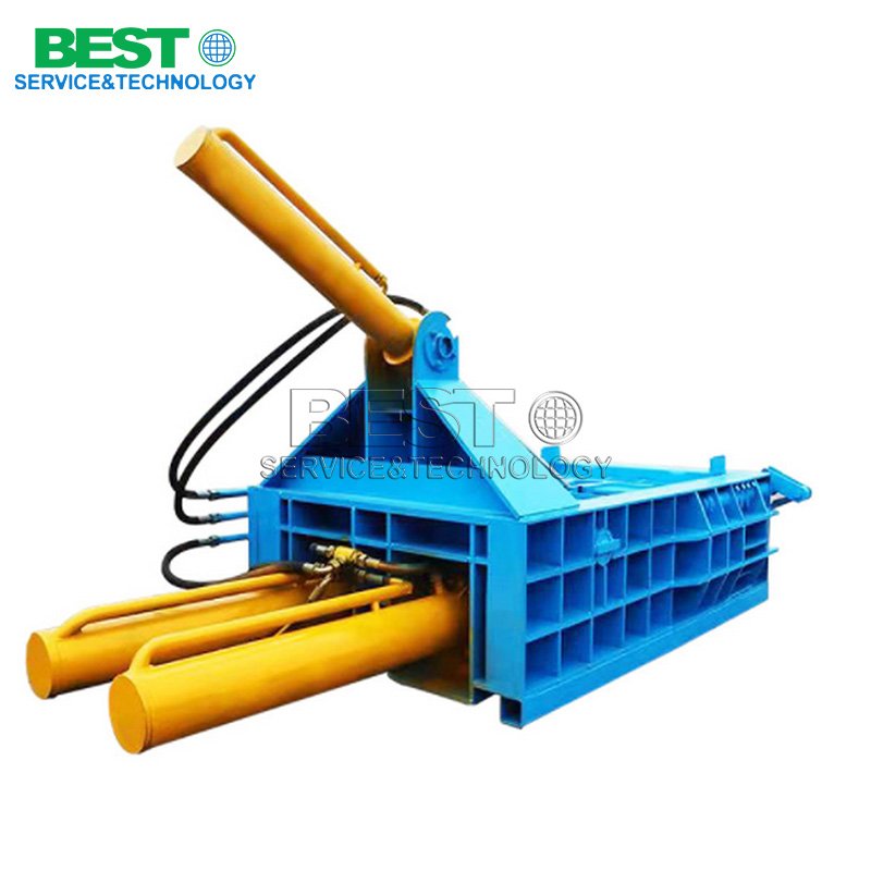 Hydraulic metal briquetting machine compressing steel chips into dense briquettes for recycling